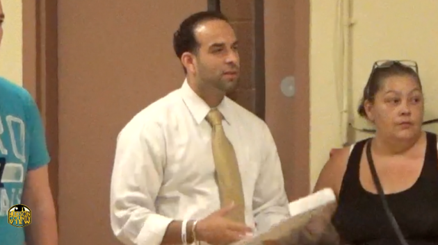 Carmelo Garcia stands in the audience during an August 26, 2014 meeting of the Hoboken Housing Authority, the first public meeting after he was fired as executive director. 