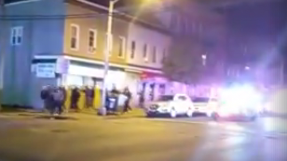 A screenshot of a Facebook video showing Bayonne police escorting a crowd back to the Jersey City border. 